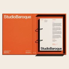 an orange book opened on top of a white background with the title studiobarque written in black