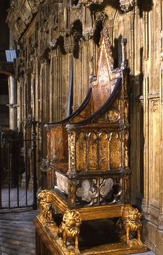 an ornate wooden bench in the middle of a building