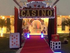 a red carpeted walkway leading to a casino entrance with dice and cards on it