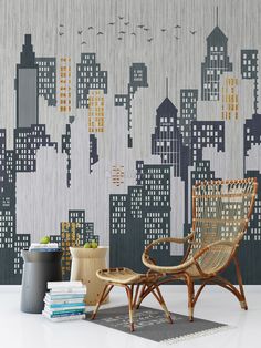 a chair and ottoman in front of a cityscape wallpapered with buildings