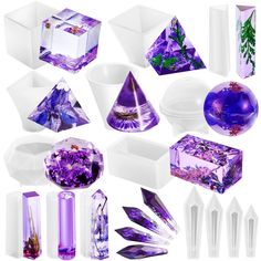 several different shapes and sizes of purple crystal objects in white boxes, including candles, vases, and other decorative items