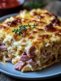 a close up of a plate of food with ham and cheese casserole on it