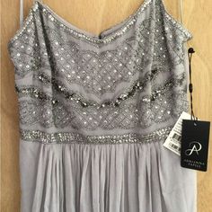 a dress hanging on a wall with a tag