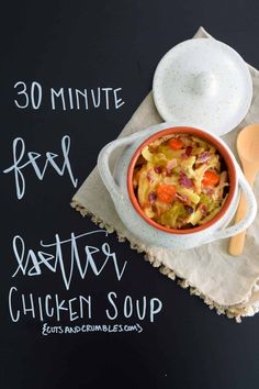 a bowl of chicken soup sitting on top of a napkin next to a plate with a spoon