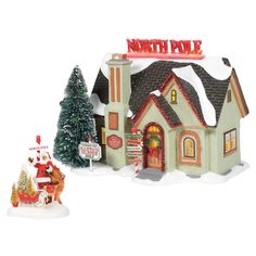 a small christmas village with a santa clause on his sleigh next to it