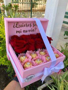 a pink box with red roses in it