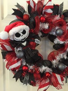 a wreath decorated with red, white and black decorations