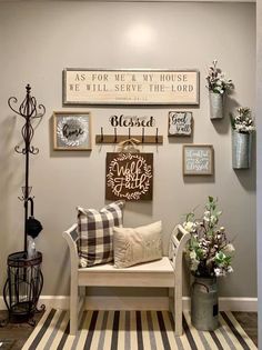 a living room filled with lots of furniture and decor on the wall next to a striped rug