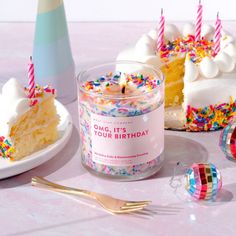 a birthday cake is next to a candle and some confetti