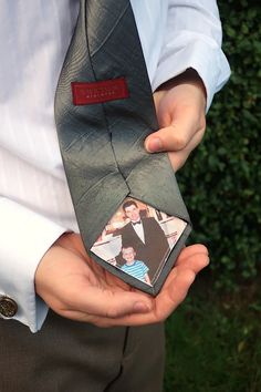 a man is holding his tie with an image on the front and back of it