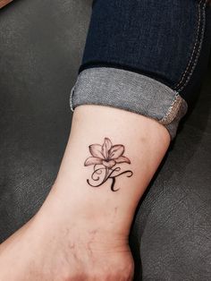 a woman's foot with a flower tattoo on it