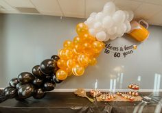 balloons and desserts are arranged on a table