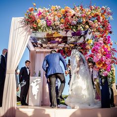 a bride and groom walking down the aisle