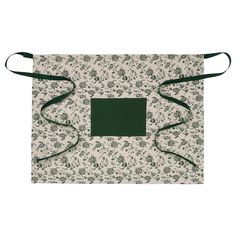 a green and white flowered bag with black straps