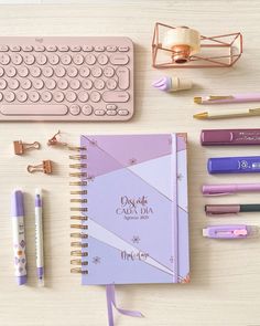 the contents of a planner, pen, keyboard and other office supplies laid out on a table