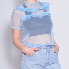 This Sheer Ruffle Tee features a mock neck design with modern Victorian flair. Crafted from elastic mesh, this transparent blue top has a stylish keyhole back, making it perfect for parties and special occasions. Detail: * Fabric: feels like synthetic * Condition: very good vintage,  * Circa: 2000s * Care Label missing Fit: * Best fit Small, US 6  * * Please refer to measurements below for a proper fit * MEASUREMENTS: Length - 22.0" - 56cm Shoulder to shoulder - 13.75" - 35cm Sleeve - 7.5" - 19.5cm Armpit - 17.5" - 44.5cm Waist - 16.75" - 43cm Bottom - 18.0" - 46cm The sizes in the listing titles are estimates, please make sure to compare the measurements with a piece you own, to make sure the item will fit. Taken from seam to seam while the garment is lying flat. Double the armpit, waist, Modern Victorian Style, Ruffle T Shirt, Modern Victorian, Party Tops, Mock Neck, Neck Designs, Victorian Fashion, Womens Clothing Tops, Favorite Outfit