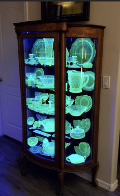 a lighted display cabinet with dishes in it