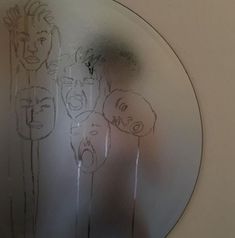 a mirror that has some drawings on it