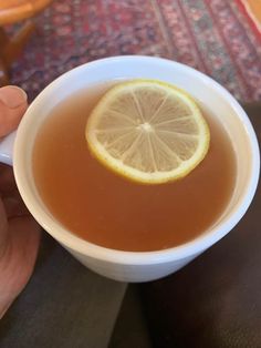 a cup of tea with a lemon slice in it