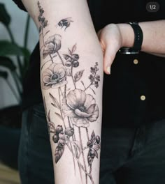 a woman with a flower tattoo on her arm