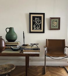 a table with books, vases and other items on it in a living room