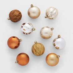 an assortment of christmas ornaments on a white surface