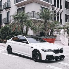 a white car parked in front of a building