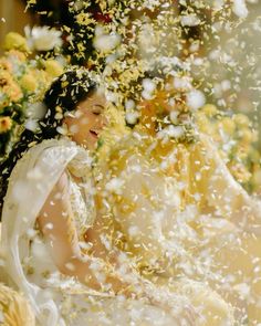 the bride and groom are surrounded by confetti as they sit in front of each other