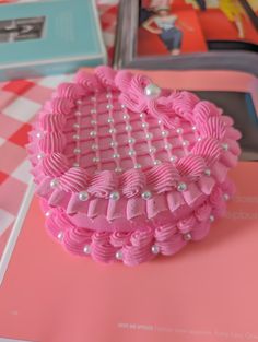 a close up of a cake on a table with pink and white checkered cloth