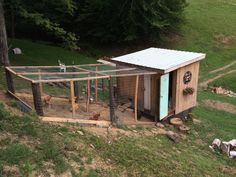 a small chicken coop in the middle of a field