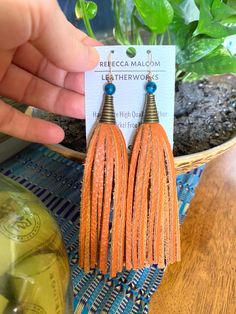 'Phyllis' Statement Tassel Earring-Orange Your go to earrings for all occasions.  Whether your wearing your favorite tank top or going to a special occasion...these ladies will compliment all of your outfits! Tassel earrings combined with Natural Stone make for a perfect Boho Earring. Each pair is handmade by yours truly, so truly unique and one of a kind. -Made from premium leather, yet lightweight. -Accented with Natural Jade Stone-Turquoise color. -Dangle and Drop Length- Approximately 5" -All metals are Nickel-Free, non Allergenic. I have very sensitive skin so I only use metals that will never irritate sensitive skin. -Free Shipping on all orders over $35 These are available in other colors at well, Remember to follow my shop for updates and new listings!  Please tag your pics on my I Bohemian Orange Tassel Earrings, Brown Fringe Tassel Earrings For Gift, Brown Fringe Tassel Earrings As Gift, Brown Fringed Tassel Earrings Gift, Adjustable Orange Tassel Earrings, Bohemian Orange Fringe Earrings, Orange Tassel Dangle Earrings, Orange Tassel Earrings, Orange Fringe Dangle Earrings