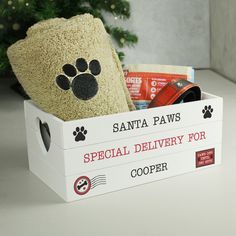 a stuffed animal in a box with its paw on it's head and the words santa paws special delivery for bella