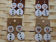 four pairs of snowman earrings are on display