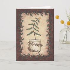 a christmas card with a plant in a coffee cup