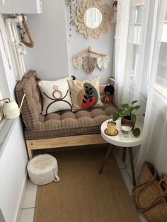 a living room filled with lots of furniture next to a white wall and window sill