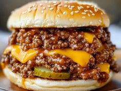 a hamburger with cheese and pickles on it