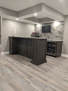 an empty basement with a bar in the middle