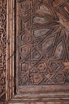 an intricate wooden door with carvings on it