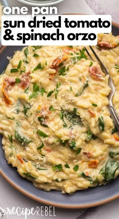 a blue plate topped with pasta and spinach