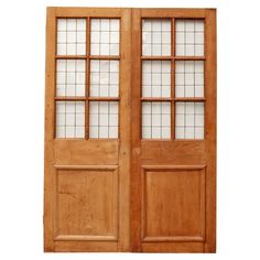 two wooden doors with glass panels on the top and bottom, both side by side