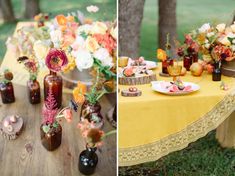 a table topped with vases filled with flowers next to an empty bottle full of drinks