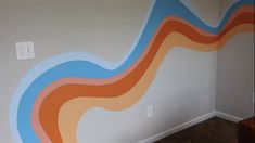 an empty room with a painted wave on the wall