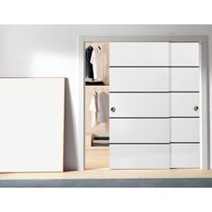 an open closet with white doors and drawers