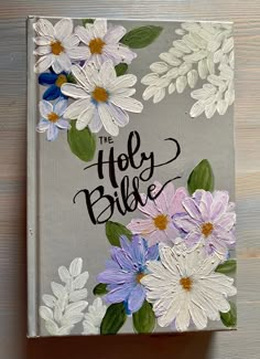 a book with flowers painted on the cover