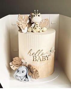 a baby shower cake decorated with giraffes and leaves