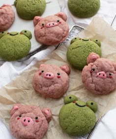 some cookies that are shaped to look like pigs and frog heads on top of each other