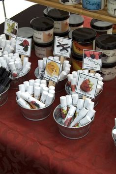 there are many jars and containers on the table with labels for different things to put in them