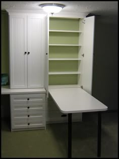 a white desk and cabinet in a room with carpeted flooring on the ground