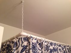 a blue and white curtain hanging from the ceiling