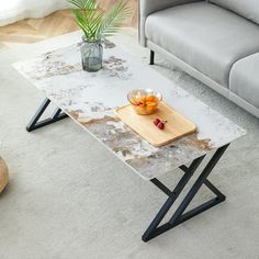 a living room with a couch, coffee table and vase on the carpeted floor